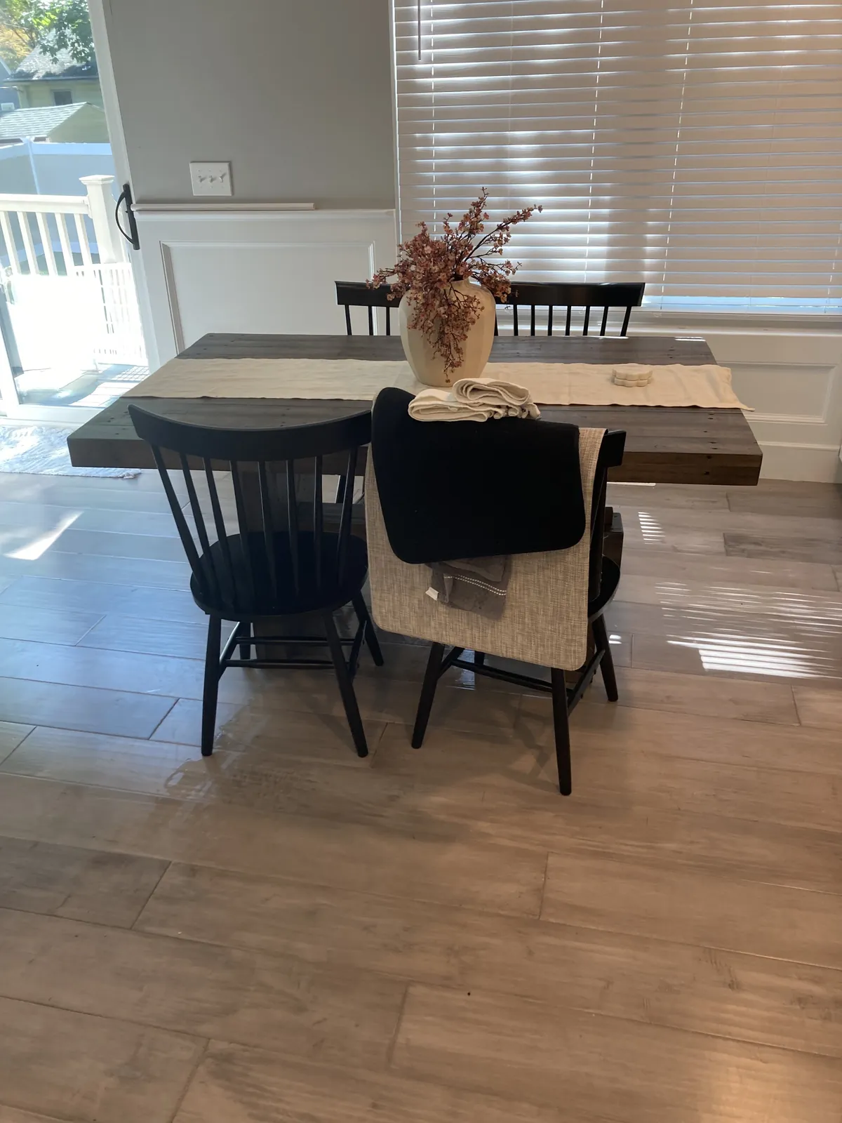 Bright dining room with a table, chairs, and hard flooring
