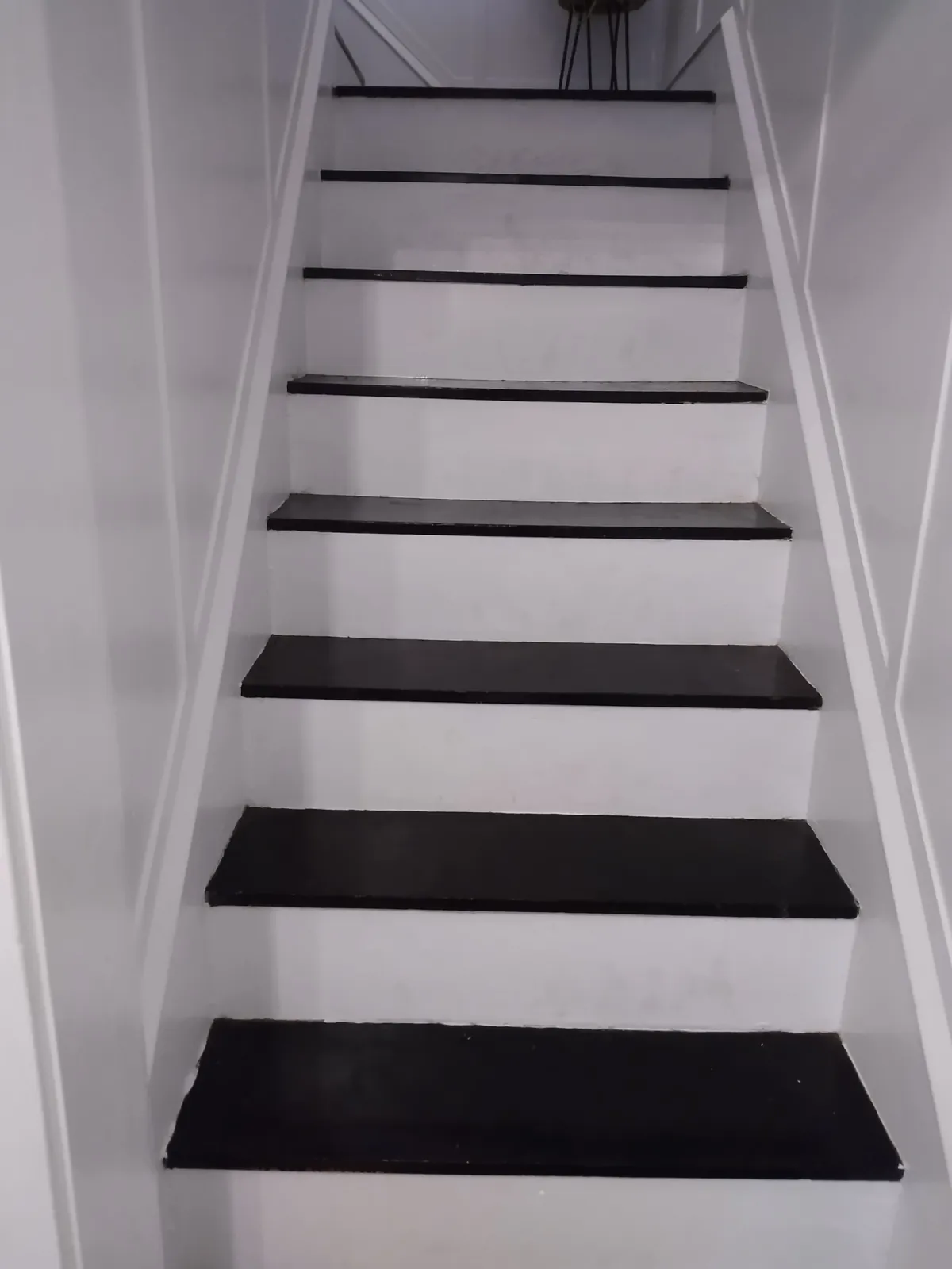 Painted interior staircase with dark treads and white risers