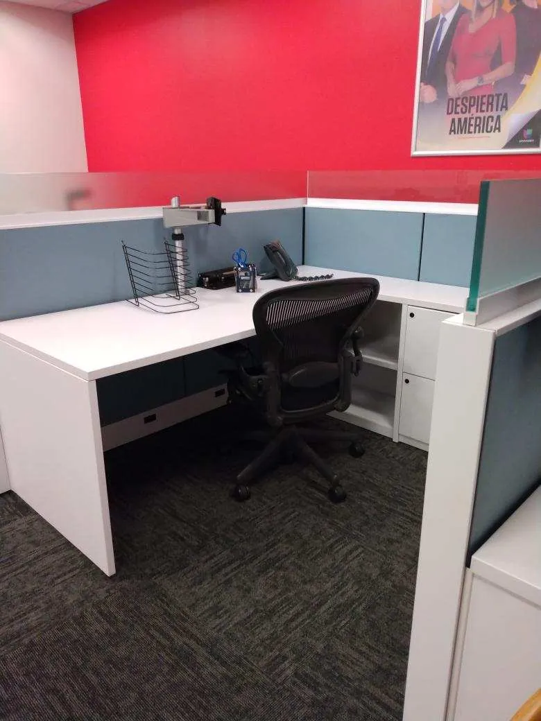 Red office workstation with cabinets and a desk chair