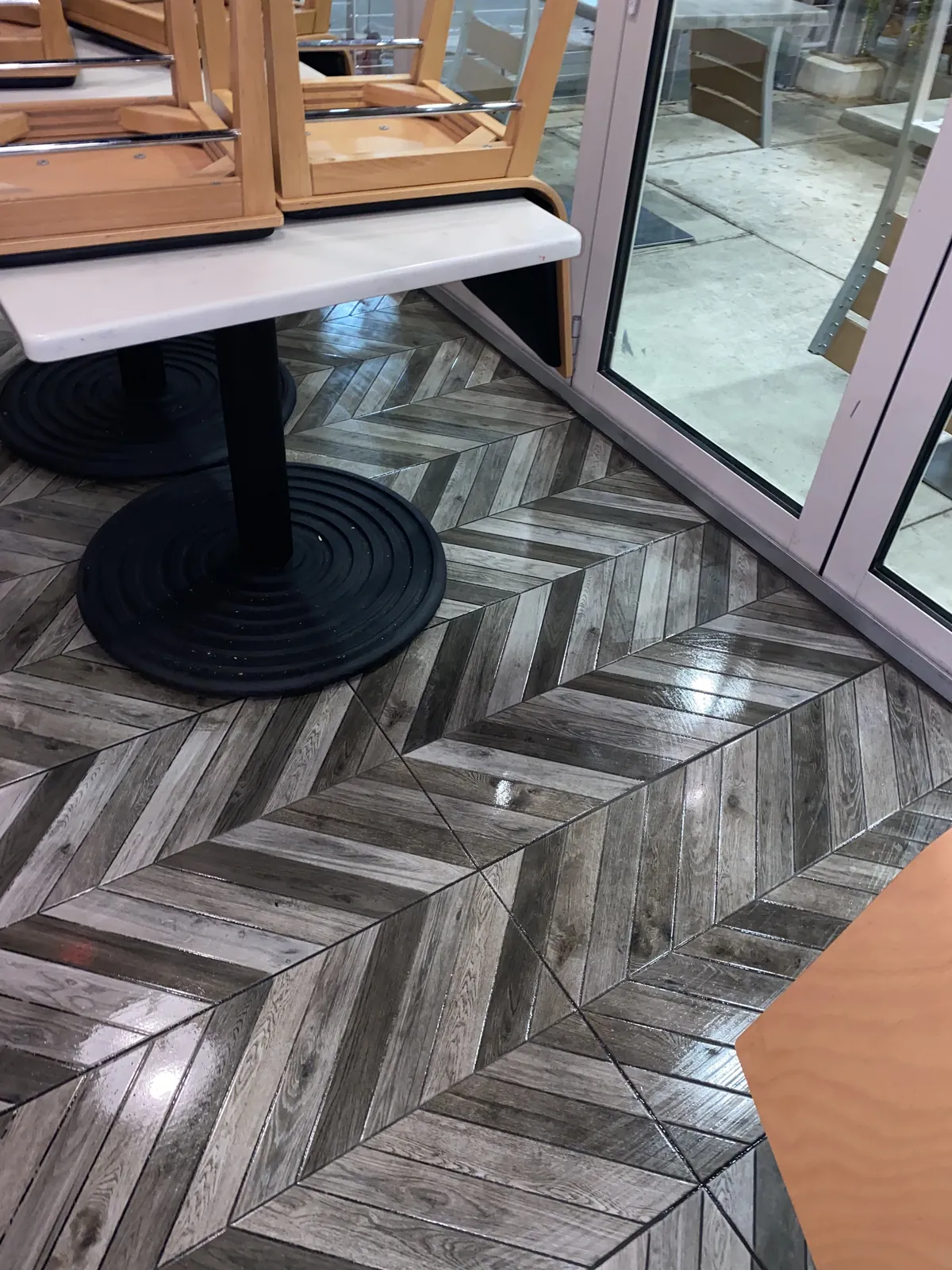 Glossy patterned tile floor in a commercial dining area