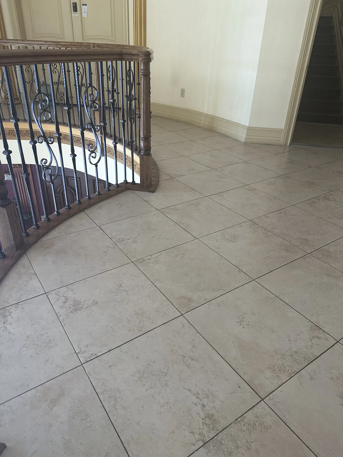 Ornate tiled stair landing with a decorative railing