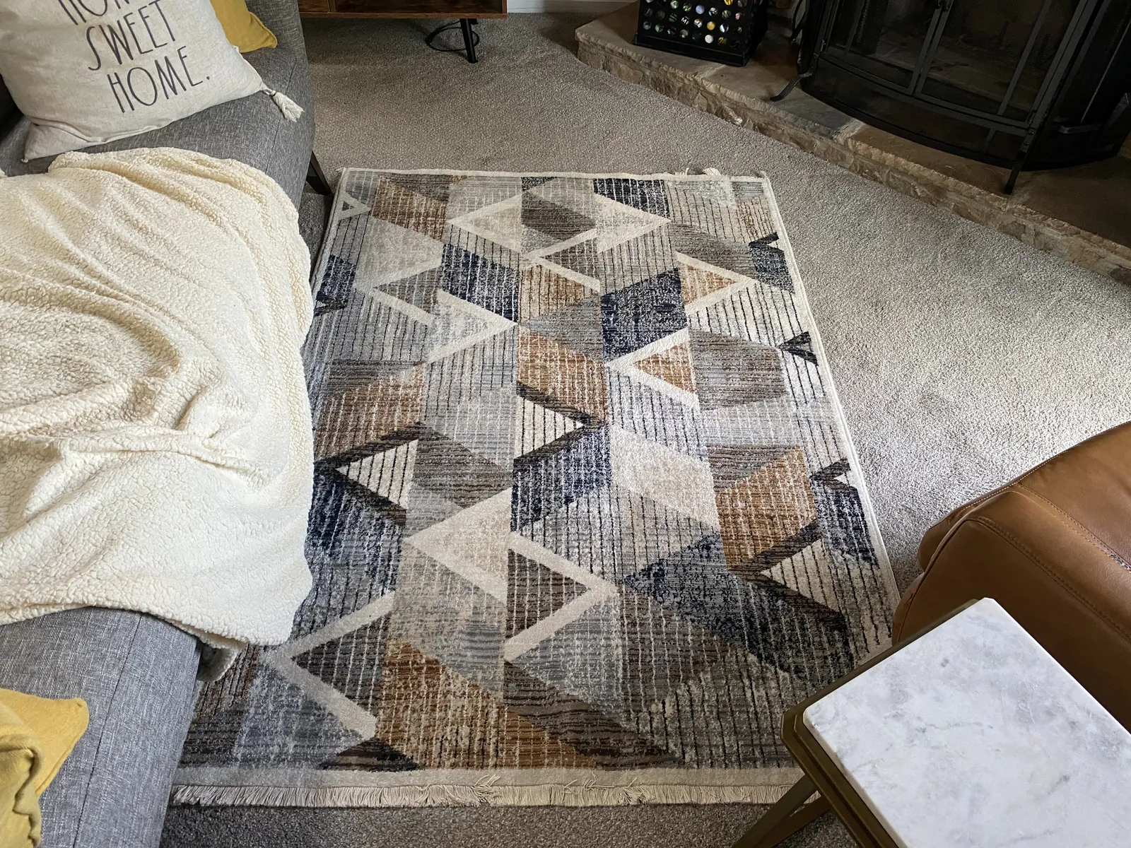 Patterned area rug centered on a living-room floor