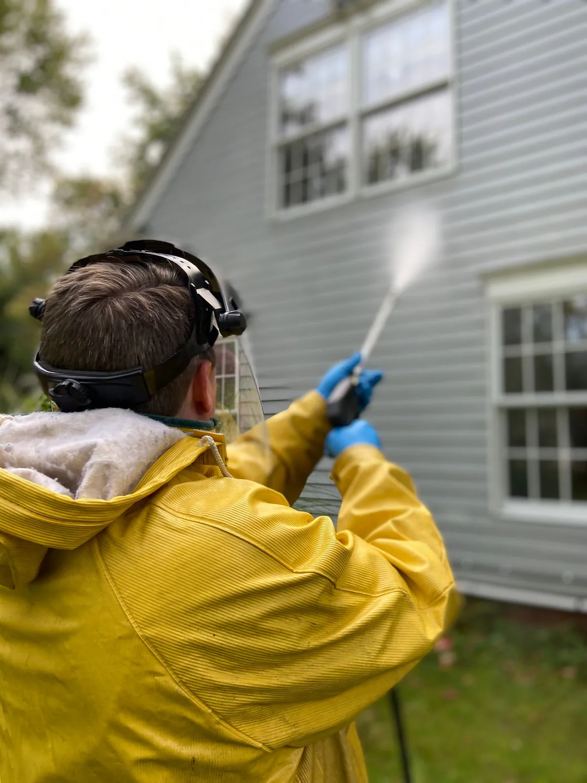 Outdoor hard surface being prepared for power washing